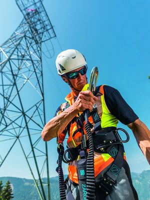 Industriekletterer während der Vorbereitung auf seine Arbeitsplatzpositionierung mit vollständiger Fall Protection-Ausrüstung